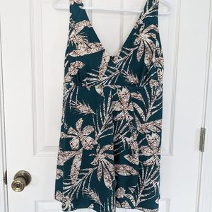 One piece bathing suit with tropical leaf design.